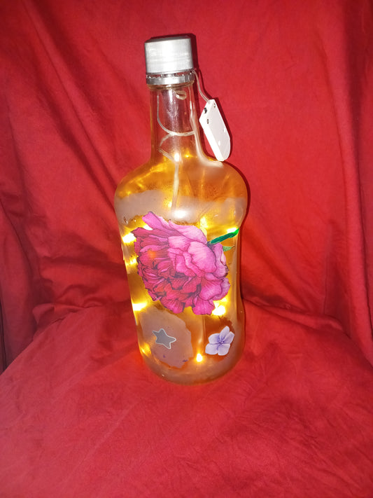 Hand painted lg bottle w/ lg pink flower, small purple flowers and fairy lights